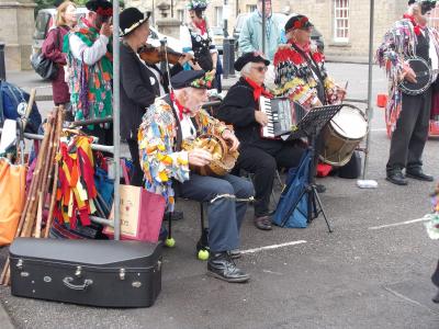 An eclectic mix of instruments on the Market Place including a hurdy-gurdy