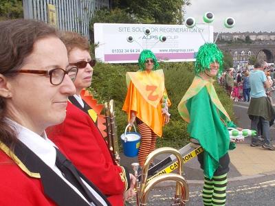 Burbage Band waits to join the Carnival Parade alongside the three-eyed monsters from the planet Zog - also Sam Slide's front of house team! (SS 2019)