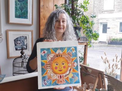The New Mills artist Joanna Allen shows off the original artwork for her winning entry, a collagraph (photo credit: Gaye Chorlton)