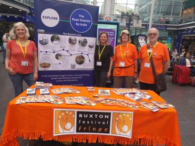 From l-r, High Peak & Hope Valley Community Rail representatives Helen Wright and Catherine Croney join Pam Mason and Ian Bowns of the Fringe in a pre festival promotion at Manchester Piccadilly to encourage people to travel to us by public transport (credit: Stephanie Billen 2023)