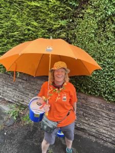 Sporting a Fringe umbrella, committee stalwart Pam Mason (credit: Linda Rolland 2023)