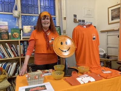 Catherine Serjeant invites you to become a Fringe Friend and buy some lovely Fringe merchandise! (credit: Moira Kean 2024)
