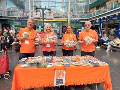 Rob, Helen, Catherine and Ian: the Fringe goes to Manchester Piccadilly promoting train and bus travel with High Peak and Hope Valley Community Rail Partnership (credit: Stephanie Billen 2025)