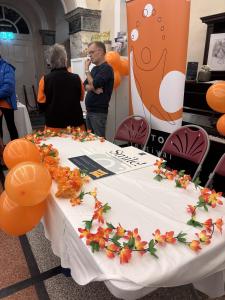 Peter and Jeanette next to the splendidly adorned Fringe table (MK)