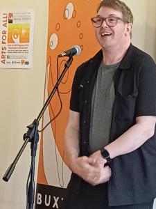 Dom Hutchins feeds off the audience's enthusiastic reception at the 2026 Programme Party (credit: Stephanie Billen)