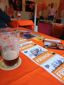 Those all-important programmes looking smart at the Programme Party with artist Andrea Joseph's cover design (SB)